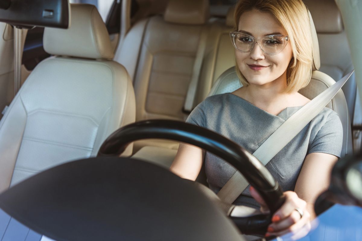 Businesswoman driving a car with Low-Cost Auto Insurance in West Babylon, NY