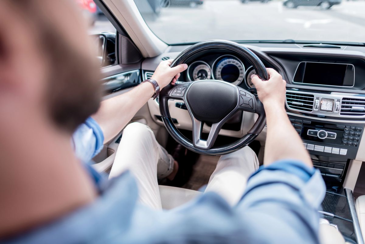 Man steering wheel with Low-Cost Auto Insurance in West Babylon, NY